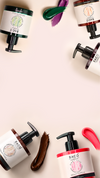 Bacò hair color products and multicolored swatches arranged around a pale pink background