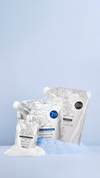 Silver product sachets arranged on a pale blue pedestal