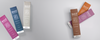 Four colorful cosmetic tubes arranged on a light gray background