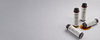 Four small cylindrical ampoules arranged on a gray background