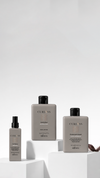 Gray haircare bottles arranged on white display blocks