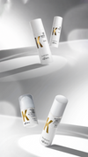 Four white Kaaral Extra K hair products on a silver background in a vertical layout