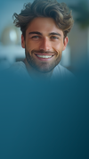 Smiling dark-haired man at the top of a dark teal vertical background