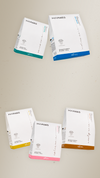 Five white Maraes travel kit boxes with colored bands on a beige background