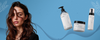 Brunette woman beside three Maraes Volume Care products on a blue background