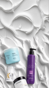 Kaaral hair masks and treatments arranged on a white cream texture background with open space above for banner content.