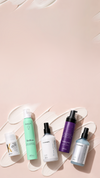 Assorted pastel product bottles arranged on a pink background