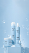 Four blue Purify Filler hair products displayed with foam and bubbles