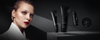 Woman with slicked-back hair beside four black Kaaral Perfetto hair styling products