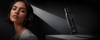 Brunette model below a black haircare product bottle