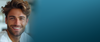 Smiling dark-haired man on the left of a teal gradient banner