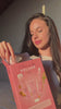 Woman demonstrating the Purify Volume gift set with shampoo, conditioner, and root spray, then showing her styled hair.