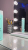 Woman using Purify Hydra haircare products in the shower and showing her long, smooth dark hair afterward.